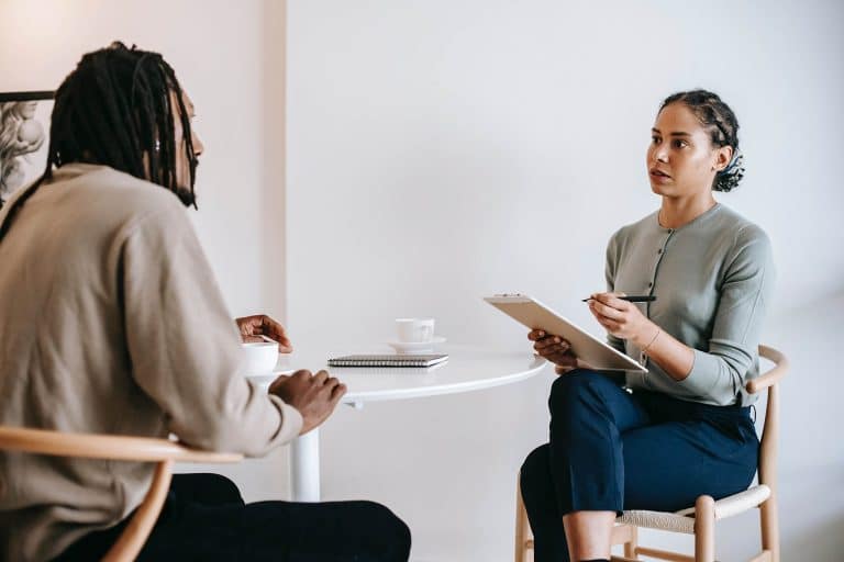 woman interviewing a man at a table